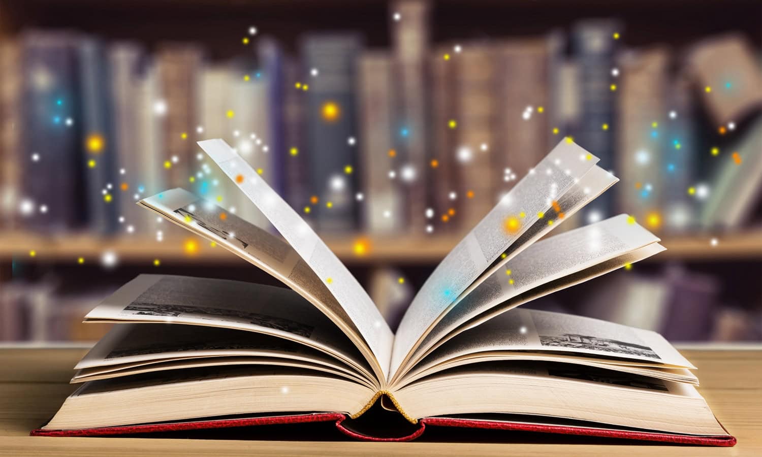 An open book with multi-coloured sparkles coming out of it.