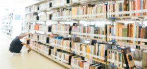 Man browsing books in a bright Library